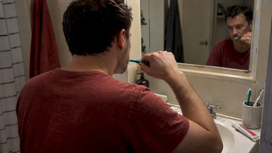 Adult brushing teeth before bed